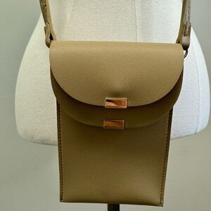 Mellow World cross-body strap, two flap closures with magnetic snaps. NWOT